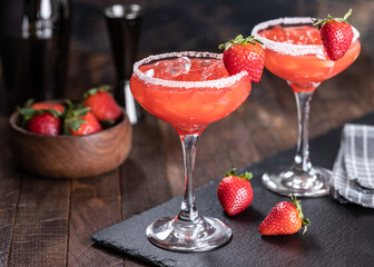 Strawberry margarita cocktail with strawberries and salt rim - 579040208