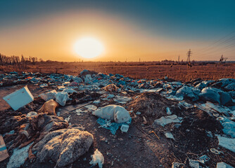 Illegal dumpster on field at sunset light, Kyrgyzstan