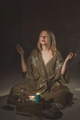 Woman sit with altar, magic among candles, clean negative energy, reiki session, wicca concept
