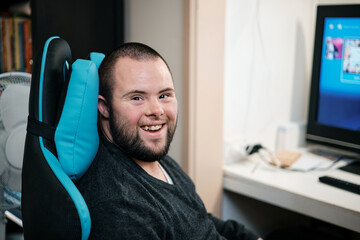 Young Man with Down Syndrome about to do some Video Gaming