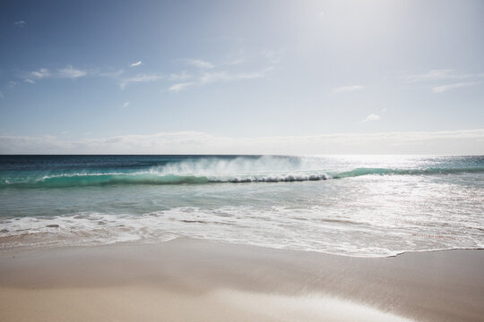 Waves on beach in morning light