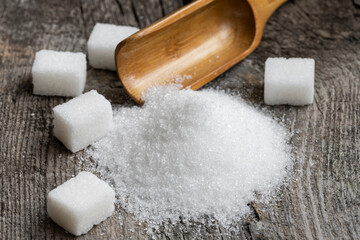 Crystal white granulated sugar. Crystal sugar photos on wood for diabetics to stay away from