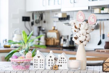 Key to house of cozy home with Easter decor with rabbit and eggs on table of kitchen. Building, design, project, moving to new house, mortgage, insurance, rent and purchase real estate