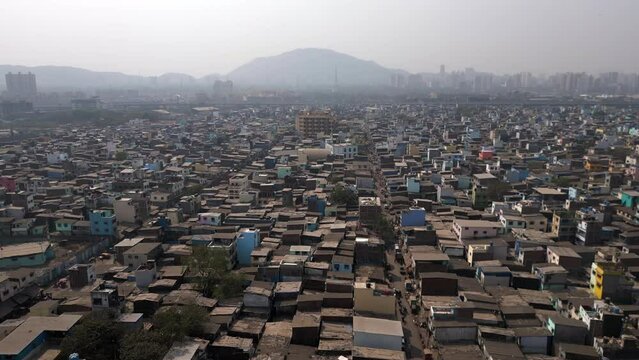 Aerial jib shot showing residential buildings in the crowded Govandi neighbourhood in the the suburbs of Mumbai, Maharashtra, India. Population growth, poverty and overpopulation concept.