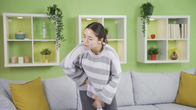Asian young woman with severe and prolonged groin pain.
Incapacitated and helpless asian young woman with pain in the groin has an inguinal hernia.
