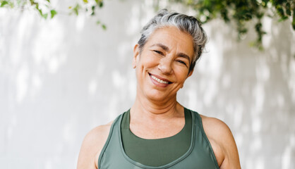 Retired and active: Mature woman smiling at the camera outdoors - Powered by Adobe