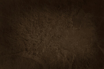 Dark brown slate stone wall texture background in natural pattern for decorative interior and exterior.