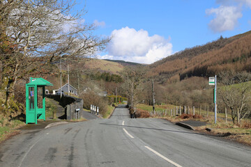 A bus stop on a country road in a beautiful rural valley in Gwynedd, Wales, UK.