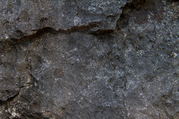 Dark old stone background with deep stone grooves