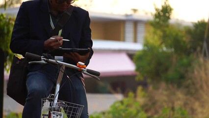 Socially responsible Asia businessman cycling to work - Powered by Adobe