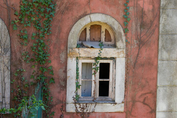 Facade of a historical building in the garden, old peeling paint wall with windows, vintage rustic background, Lisbon, Portugal