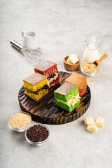 Martabak manis or terang bulan is indonesian sweet pancake, with many color and filled with chocolate chips, cheese, fruit jam, butter and peanut on concreate background.