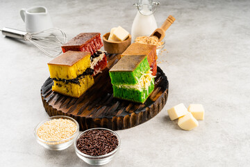 Martabak manis or terang bulan is indonesian sweet pancake, with many color and filled with chocolate chips, cheese, fruit jam, butter and peanut on concreate background.