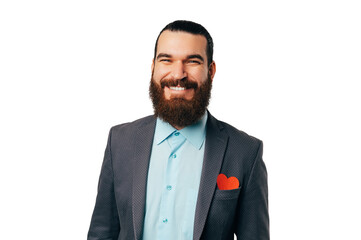Handsome bearded man wearing jacket has a small red heart in his pocket.