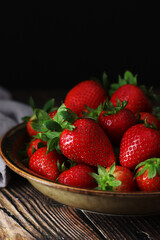 A bowl with ripe bright strawberry in rustic style