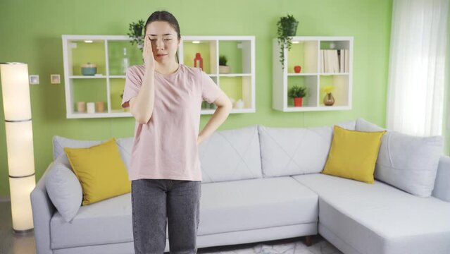 Young asian woman losing her balance and dizzy is fainting.
Asian young woman who lost her balance at home faints and falls to the ground.
