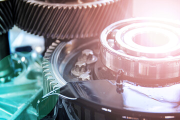 Detailed photo of an electric vehicle transmission. Main gears and ball bearing are highlighted. Selective focus. Flare effect. Toned