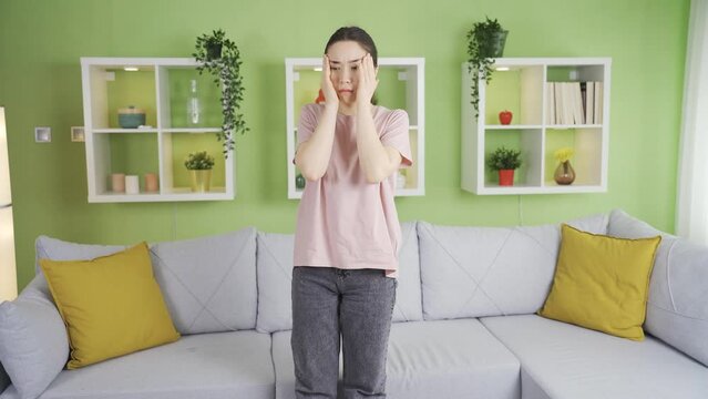 Asian woman fainting as a result of dizziness.
Asian young woman fainting at home as a result of sudden dizziness and loss of balance.
