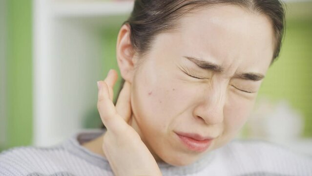 Young woman with otitis media feels severe and prolonged pain.
Young asian woman with inflammation in her ear feeling pain and soreness.
