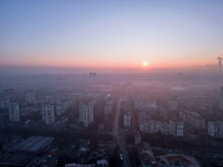 Fototapeta na wymiar Foggy sunrise over Sofia(Bulgaria) city viewed from drone - eastern area with view to the East
