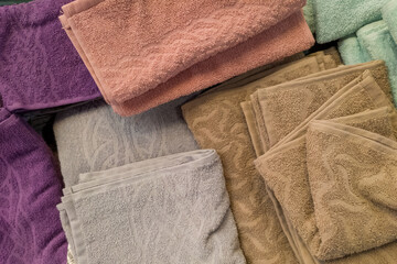 Lots of clean multi-colored towels stacked on top of each other