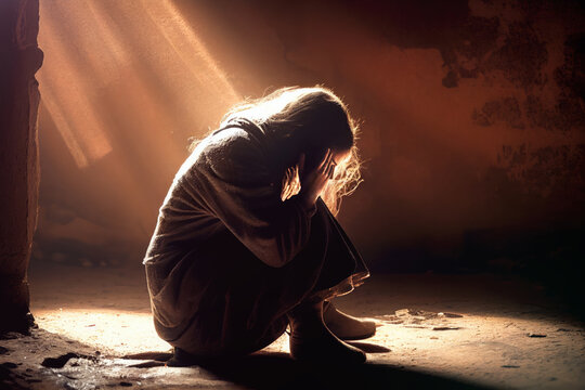 Einsame weinende Frau kniet im Keller im Lichtstrahl