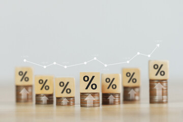 Finance interest rates and mortgage interest rates Icon on wooden block with percentage symbol and arrows pointing up Economic conditions