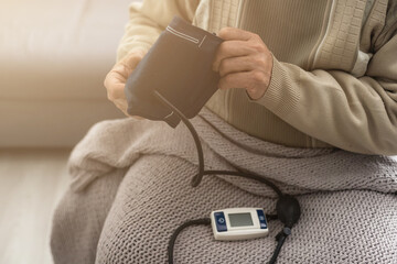 Elderly Man check blood pressure and heart rate at home with digital pressure very high blood pressure test results. Risk for cardiology. Need some medicine. Health and Medical concept.