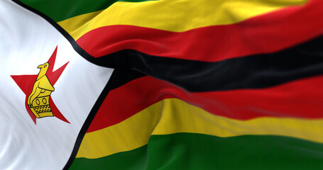 Close-up view of the Zimbabwe national flag waving in the wind - obrazy, fototapety, plakaty