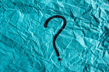 Question mark drawn on a blue paper. Curiosity, uncertainty and confusion concepts. Conceptual image.