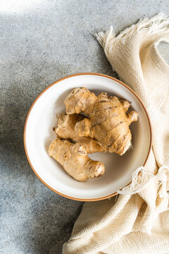Overhead view of a bowl with a fresh ginger root