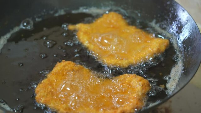 A chef is making deep-fried cutled  Pork and fried cutled Chicken