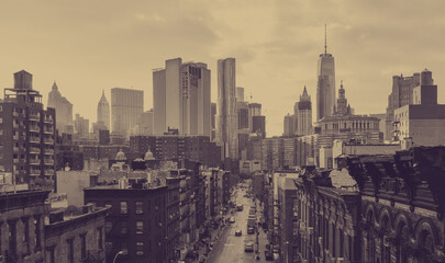 New York City overhead view of Madison Street in Chinatown and the downtown skyline buildings with faded sepia color effect