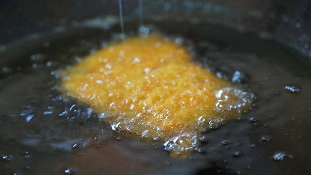 A chef is making deep-fried cutled  Pork and fried cutled Chicken