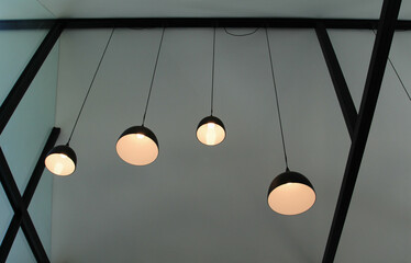 The black 4 lamps hanging from the ceiling