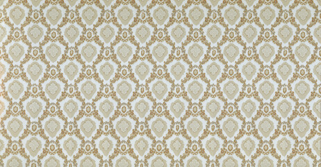 Old wallpaper on the wall. Old wallpaper for texture or background.