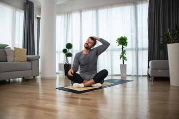 Strong sweaty athletic fitness business man in sportswear doing exercises and home workout in his...