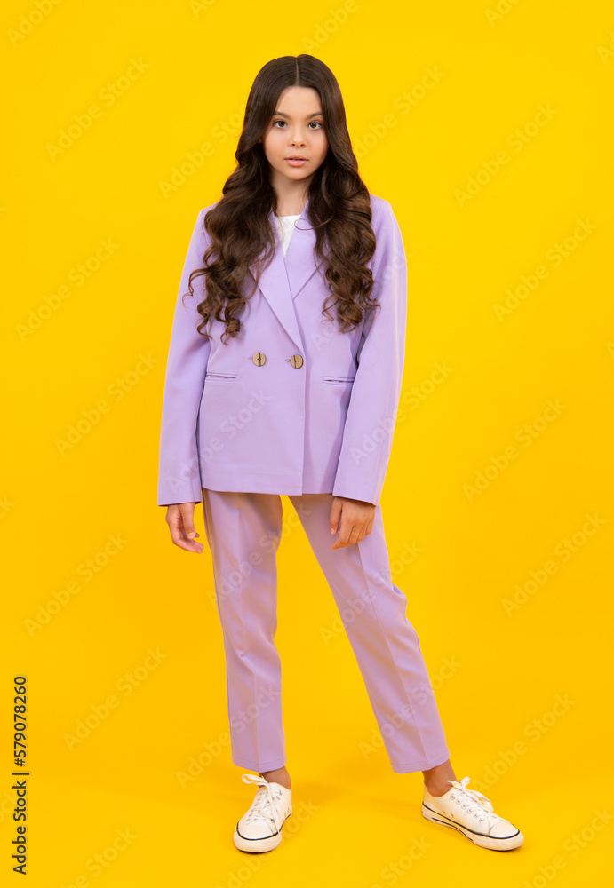 Wall mural full length photo of pretty teenager child girl wear casual clothes isolated on yellow background.