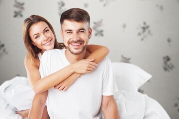 Pleased young Man and woman In Bed After sleep,