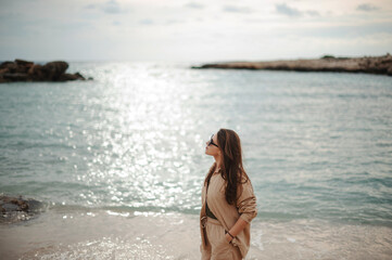 Young woman looking at the water surface at the beach