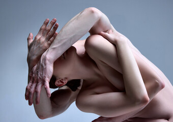 Impersonal portrait of young couple in love. Naked man and woman in sensual plexus of bodies....