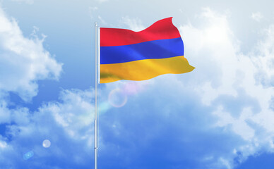 Armenian flag on sky.Armenia flag flying in wind against bright day sky.Waving flag of Armenia on flagpole on blue sky background