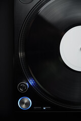 DJ turntable in flat lay. Professional vinyl record player shot directly from above on black background