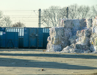 stacked compressed bales of plastic waste at recycling yard. Factory plastic waste being recycled.