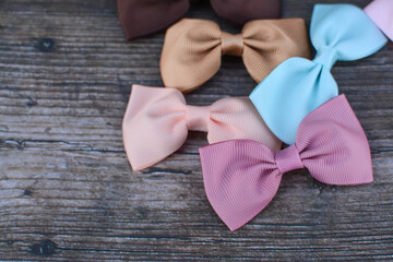 Pastel colors hair bows on dark wooden background