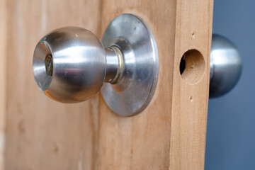 Stainless doorknob and keyhole on old wooden door, Macro shot