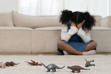 Child girl scared of toys dinosaurs. Girl play with dinosaurs toys for educational. Educational...