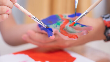 Hands little the girl painted colorful happy watercolor artist for child's hands background White paper.
