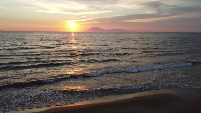 Beautiful sunset in Greece. Flying sideways at the coast and view to sunset. View to island of Kefalonia	