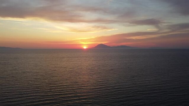 Amazing sunset scenery in Greece. Flying into the sunset. View to island of Kefalonia. Shot in Kyllini Beach.
